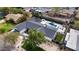 A stunning aerial shot showcasing the property's layout with a pool, manicured landscaping, and stylish outdoor seating at 3033 E Roma Ave, Phoenix, AZ 85016