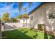 A well-kept backyard featuring an artificial lawn, modern design, and a sleek barbecue grill for outdoor enjoyment at 3033 E Roma Ave, Phoenix, AZ 85016