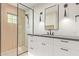 Modern bathroom with sleek vanity, stylish mirror, and glass-enclosed shower at 3033 E Roma Ave, Phoenix, AZ 85016