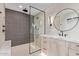 Contemporary bathroom features a glass enclosed shower, modern tiling, and wood vanity at 3033 E Roma Ave, Phoenix, AZ 85016