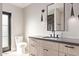 Bathroom with wood vanity, modern lighting fixtures, and a toilet visible to the left at 3033 E Roma Ave, Phoenix, AZ 85016