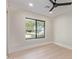 Bedroom with neutral walls, white trim, wood flooring, and window offering an outside view at 3033 E Roma Ave, Phoenix, AZ 85016