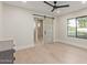 Well-lit bedroom with a modern sliding door to the bathroom and large window at 3033 E Roma Ave, Phoenix, AZ 85016