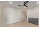 Bedroom with a modern ceiling fan, light walls, wood floors and a gray dresser at 3033 E Roma Ave, Phoenix, AZ 85016