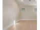 Bright, neutral bedroom features wood flooring, white trim, and a modern window at 3033 E Roma Ave, Phoenix, AZ 85016