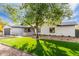 Well-manicured front lawn complements this modern home's stylish design at 3033 E Roma Ave, Phoenix, AZ 85016