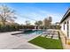 Inviting pool area with sun loungers, manicured landscaping, spa, and stylishly designed backyard at 3033 E Roma Ave, Phoenix, AZ 85016