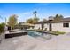 Beautiful backyard pool with hot tub, sun loungers, lush landscaping, and clean modern design at 3033 E Roma Ave, Phoenix, AZ 85016