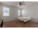 Neutral bedroom with ceiling fan, carpet flooring and natural light coming from two windows at 30940 W Indianola Ave, Buckeye, AZ 85396