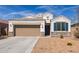 Charming single-story home with stone accents, two-car garage, and low-maintenance desert landscaping at 30940 W Indianola Ave, Buckeye, AZ 85396