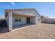 Back exterior with a covered patio and low-maintenance desert landscaping at 34074 N Beeblossom Trl, San Tan Valley, AZ 85144