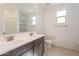 Bathroom with double sink vanity, large mirror, and open shelving at 34074 N Beeblossom Trl, San Tan Valley, AZ 85144