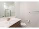 Bright bathroom features modern fixtures, a glass-enclosed shower, and a wood-grain vanity at 34074 N Beeblossom Trl, San Tan Valley, AZ 85144