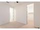 Spacious bedroom with neutral carpet, a ceiling fan, and an adjacent closet and bathroom at 34074 N Beeblossom Trl, San Tan Valley, AZ 85144