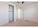 Bedroom with neutral carpet, ceiling fan, and a closet with sliding doors at 34074 N Beeblossom Trl, San Tan Valley, AZ 85144