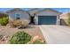 Charming single-story home with desert landscaping and a two-car garage at 34074 N Beeblossom Trl, San Tan Valley, AZ 85144