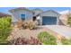 Attractive one-story home with a desert landscape and a two-car garage at 34074 N Beeblossom Trl, San Tan Valley, AZ 85144