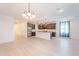 Open kitchen with stainless steel appliances, white subway tile backsplash and island with bar seating at 34074 N Beeblossom Trl, San Tan Valley, AZ 85144