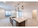 Open kitchen with a large island, stainless steel sink, and modern pendant lighting at 34074 N Beeblossom Trl, San Tan Valley, AZ 85144