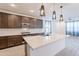 Stylish kitchen with stainless steel appliances, a large island, and modern pendant lights at 34074 N Beeblossom Trl, San Tan Valley, AZ 85144