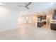 Open-concept living room and kitchen with modern stainless steel appliances and a large island at 34074 N Beeblossom Trl, San Tan Valley, AZ 85144