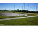 Outdoor basketball court area surrounded by green grass and a clear blue sky at 35322 N 27Th Ln, Phoenix, AZ 85086