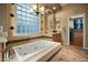 Elegant bathroom with a large soaking tub, tile accents, and modern fixtures at 35322 N 27Th Ln, Phoenix, AZ 85086