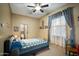 Serene bedroom with natural light, carpet, and views to the ensuite bathroom at 35322 N 27Th Ln, Phoenix, AZ 85086