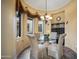 Charming breakfast nook featuring a glass-top table, four chairs, and natural light from large windows at 35322 N 27Th Ln, Phoenix, AZ 85086