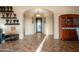 Elegant foyer featuring arched doorways, tile flooring, decorative sconces and a stained wood cabinet at 35322 N 27Th Ln, Phoenix, AZ 85086