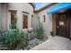 Welcoming front entrance showcasing a stylish door, attractive plants, and a stone water feature at 35322 N 27Th Ln, Phoenix, AZ 85086