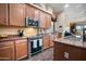 Modern kitchen featuring stainless steel appliances, granite countertops, and ample storage at 35322 N 27Th Ln, Phoenix, AZ 85086