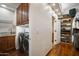 Well-organized laundry room with modern appliances and convenient built-in shelving at 35322 N 27Th Ln, Phoenix, AZ 85086