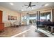 Bright living area features a piano, dining table, and sliding doors to the outdoor seating area at 35322 N 27Th Ln, Phoenix, AZ 85086