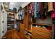 Spacious walk-in closet with custom wood shelving and ample storage space at 35322 N 27Th Ln, Phoenix, AZ 85086