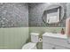 Stylish powder room featuring custom floral wallpaper and a sage-green wainscoting at 3533 E Harwell Rd, Gilbert, AZ 85234