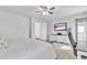 Bright bedroom with carpet, a ceiling fan, tv, and a white dresser with great storage at 3533 E Harwell Rd, Gilbert, AZ 85234