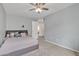 Bedroom featuring carpet, a ceiling fan, and neutral-colored walls and modern decor at 3533 E Harwell Rd, Gilbert, AZ 85234