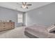 Bedroom featuring a ceiling fan, carpet, and a wooden dresser with lots of storage at 3533 E Harwell Rd, Gilbert, AZ 85234