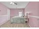 Bedroom featuring a ceiling fan, carpet, and pink walls, creating a calm retreat at 3533 E Harwell Rd, Gilbert, AZ 85234