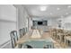 Bright dining area featuring a large wooden table, comfortable seating, and seamlessly flowing into the kitchen and living spaces at 3533 E Harwell Rd, Gilbert, AZ 85234