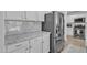 Granite countertop and stainless steel fridge in a modern kitchen at 3533 E Harwell Rd, Gilbert, AZ 85234