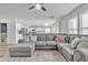 Cozy living room with a plush sectional sofa, decorative pillows, and an open layout connecting to the kitchen and dining spaces at 3533 E Harwell Rd, Gilbert, AZ 85234