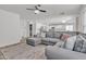 Inviting living room with a comfortable gray sectional, stylish rug, and open concept layout flowing into the kitchen area at 3533 E Harwell Rd, Gilbert, AZ 85234