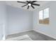 Bright, freshly painted bedroom with ceiling fan, light blue walls and view of the fenced-in houses outside the window at 3623 S 78Th Dr, Phoenix, AZ 85043