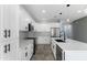 Stylish white kitchen with stainless steel appliances, sleek countertops, and modern backsplash at 3623 S 78Th Dr, Phoenix, AZ 85043