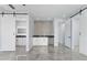 Open living space with a wet bar and sliding barn doors, featuring modern tile flooring at 3623 S 78Th Dr, Phoenix, AZ 85043