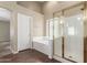 Bright bathroom with a glass shower, a large bathtub, and wood-look floors at 3751 S Vista Pl, Chandler, AZ 85248