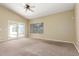 An expansive bedroom featuring carpeted floors, natural light, and a ceiling fan at 3751 S Vista Pl, Chandler, AZ 85248