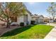 Beautiful single-story home with lush greenery, a well-manicured lawn, and a spacious two-car garage at 3751 S Vista Pl, Chandler, AZ 85248